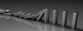 The domino effect illustrated with gray domino tiles in the process of falling one by one.