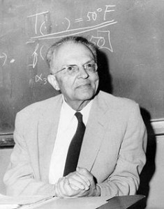 A picture of Rudolf Carnap in front of a blackboard.