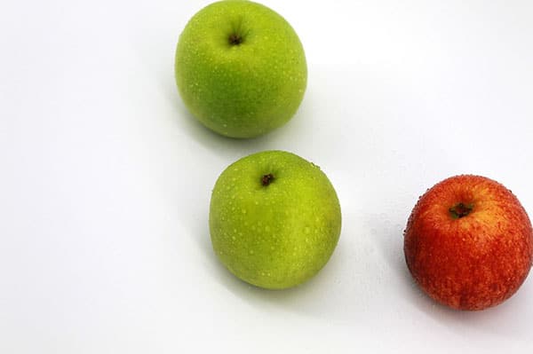 A picture of three apples (two green and one red)